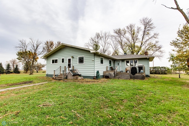 rear view of house with a yard