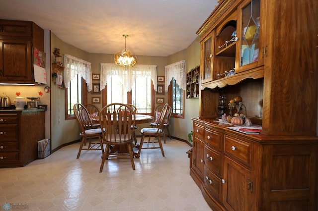 dining room with a notable chandelier and a textured ceiling