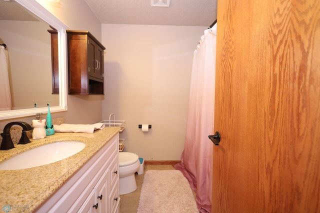 bathroom with toilet, curtained shower, and vanity