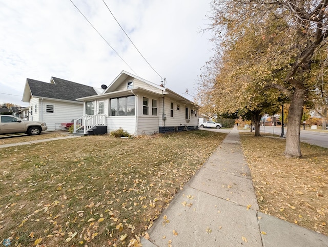 view of side of home featuring a lawn