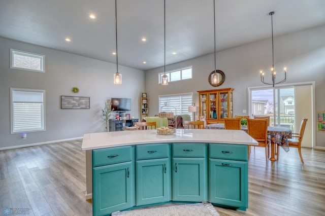 kitchen with decorative light fixtures, a high ceiling, and a wealth of natural light