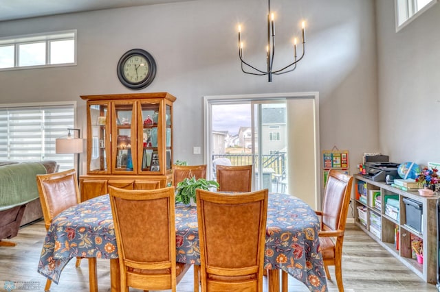 dining room featuring light hardwood / wood-style floors and a chandelier