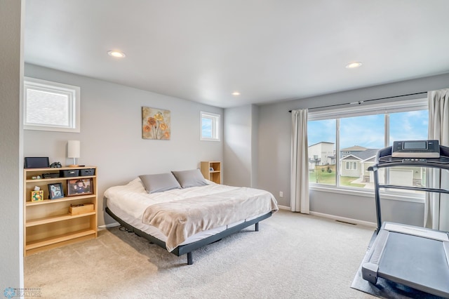 carpeted bedroom featuring multiple windows