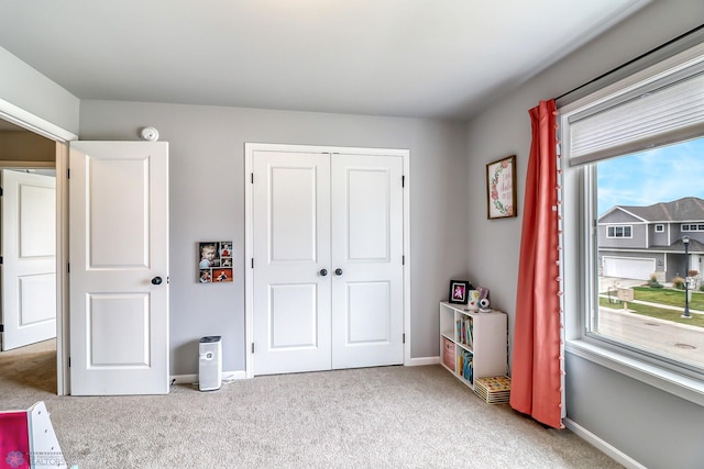 carpeted bedroom with a closet