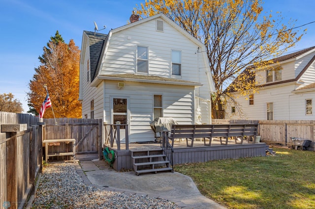 back of house with a yard and a wooden deck