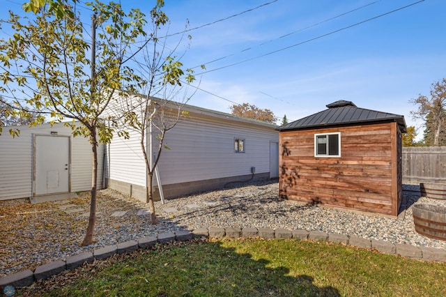 view of side of home featuring a shed