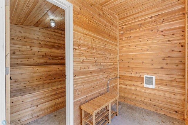 view of sauna featuring wood walls and wooden ceiling