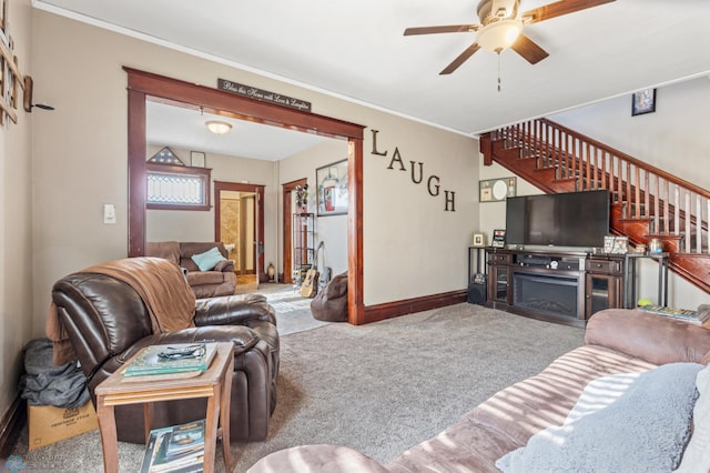 living room with ceiling fan, a fireplace, and light colored carpet