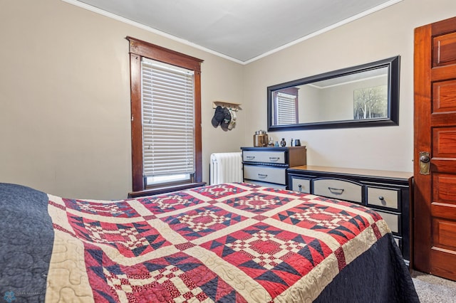 carpeted bedroom with radiator and crown molding