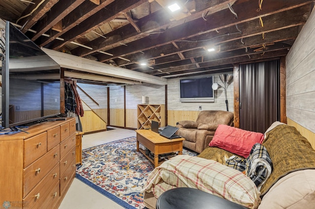 living room with concrete flooring and wooden walls