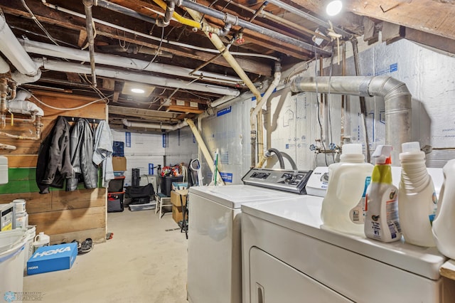 clothes washing area with washer and clothes dryer