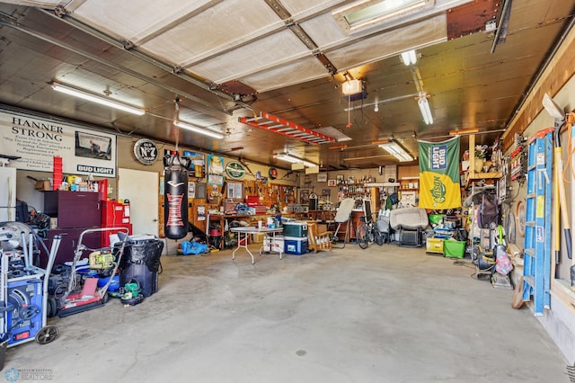 garage with a garage door opener and a workshop area