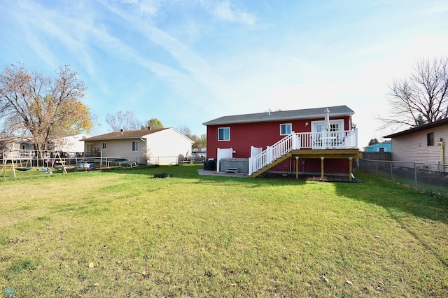 back of property featuring a yard and a deck