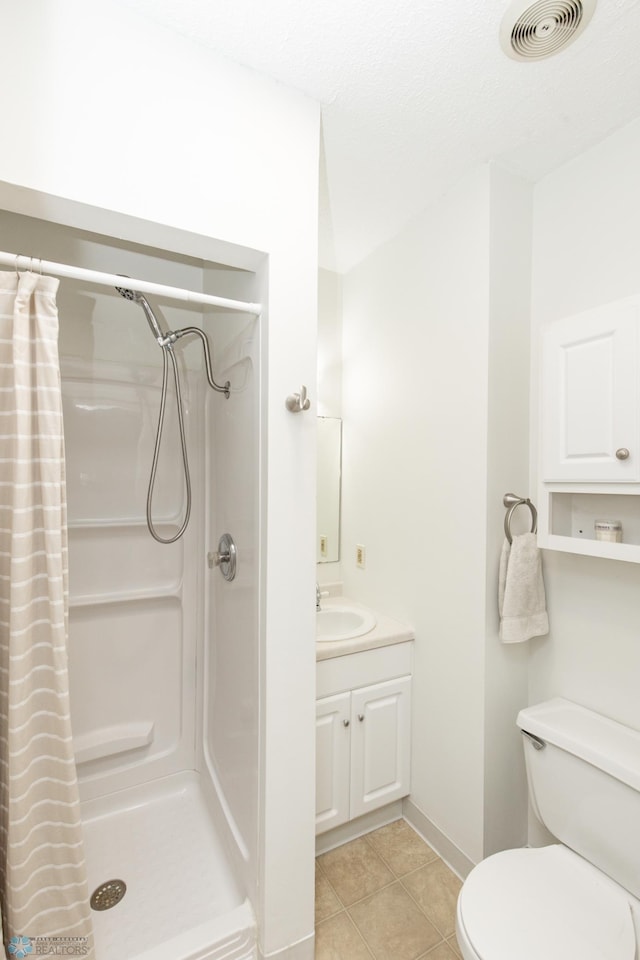 bathroom featuring vanity, toilet, tile patterned floors, and a shower with shower curtain