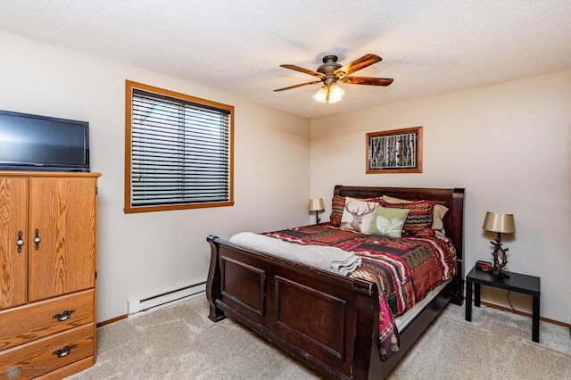 carpeted bedroom with a baseboard heating unit, a textured ceiling, and ceiling fan