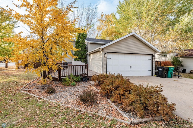 view of side of property featuring a wooden deck and a garage