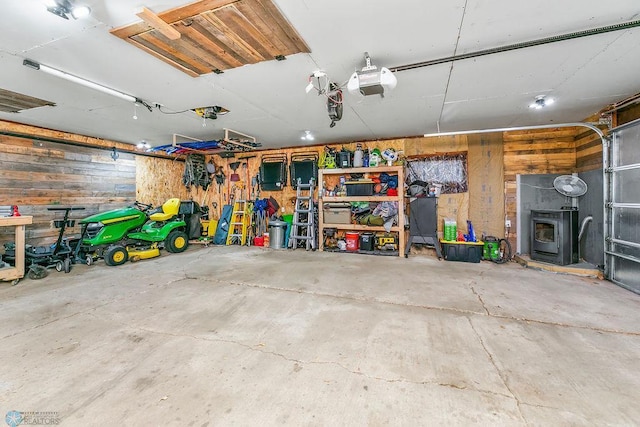 garage featuring wood walls and a garage door opener