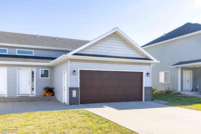 view of front of property with a front yard and a garage