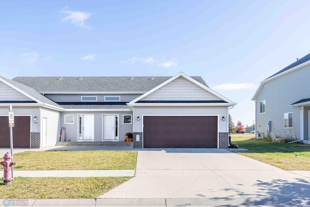 view of front facade with a front lawn and a garage