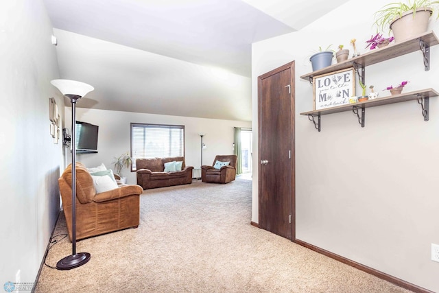 carpeted living room with lofted ceiling