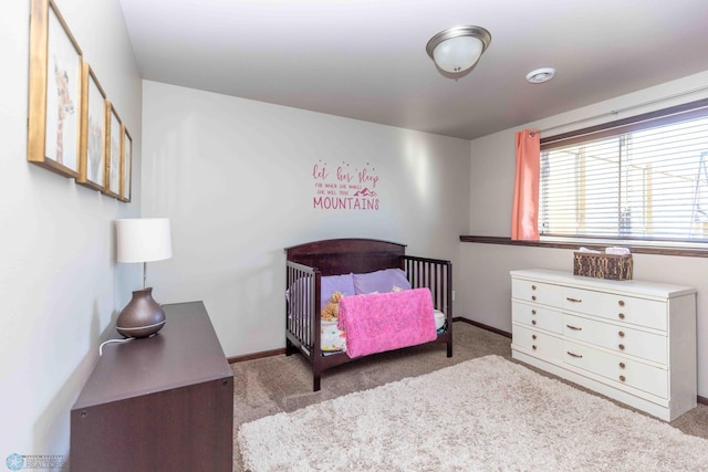 bedroom featuring light carpet