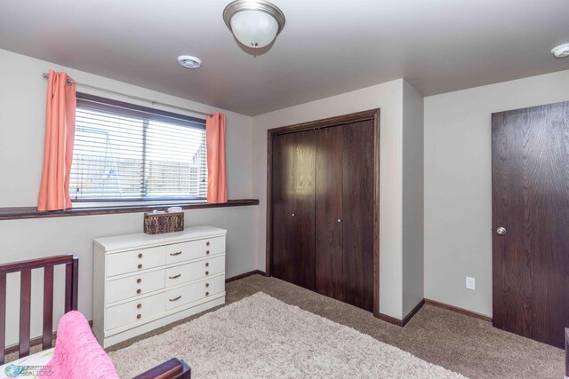 bedroom with a closet and light carpet