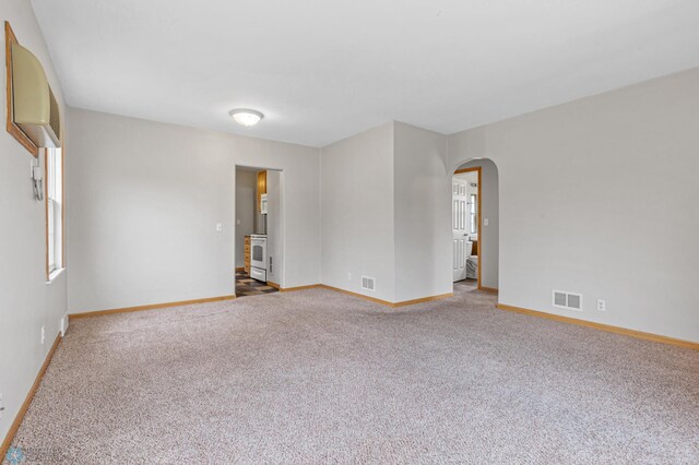 carpeted empty room with a healthy amount of sunlight