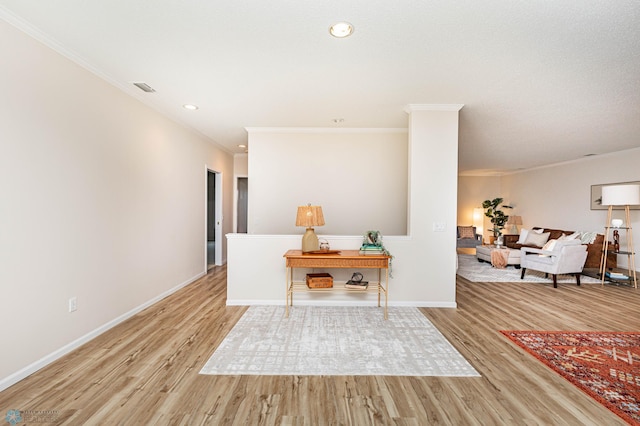 interior space featuring crown molding and light hardwood / wood-style floors