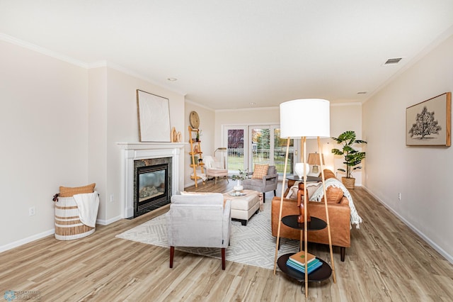 living room featuring light hardwood / wood-style floors and ornamental molding