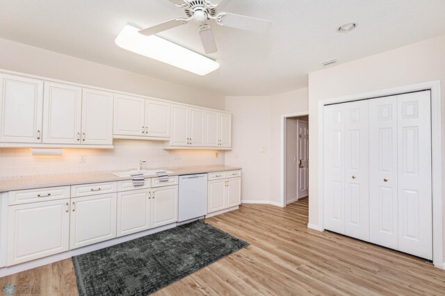 kitchen featuring white cabinets, white dishwasher, and light wood-type flooring