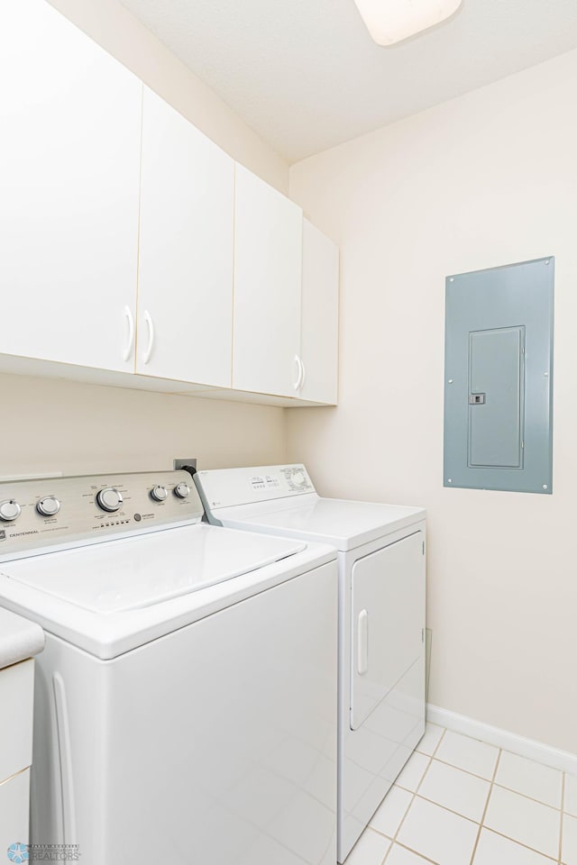 laundry area with cabinets, washer and dryer, electric panel, and light tile patterned floors