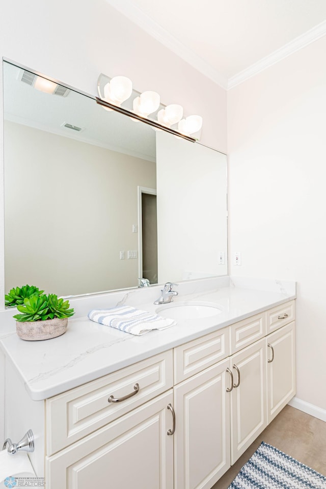 bathroom with vanity, ornamental molding, and tile patterned flooring