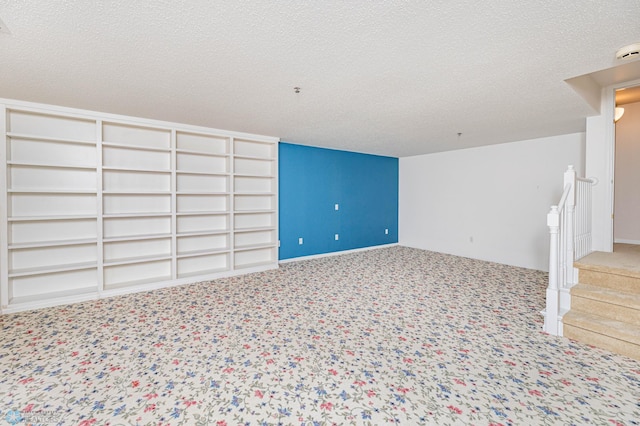 interior space with a textured ceiling and carpet floors