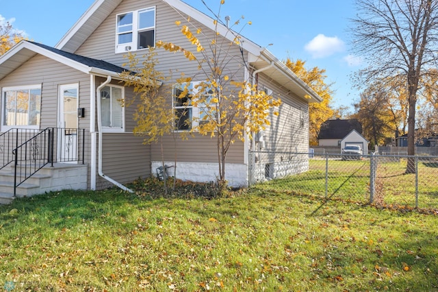 view of side of home featuring a lawn