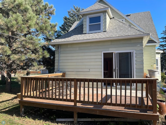 rear view of property featuring a deck