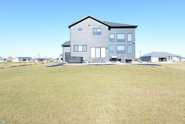 rear view of house featuring a patio area and a lawn