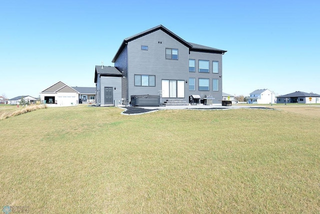 back of house featuring a patio and a lawn