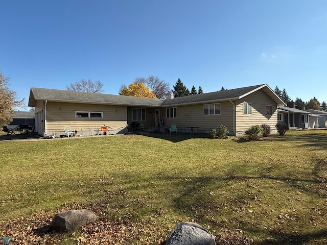 rear view of property with a lawn