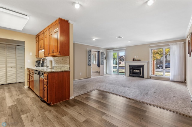 kitchen featuring light stone countertops, dishwasher, light hardwood / wood-style floors, crown molding, and sink