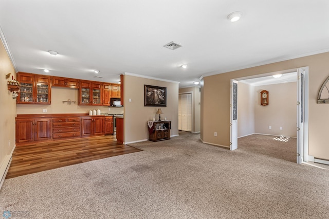 unfurnished living room featuring ornamental molding, carpet floors, and bar area