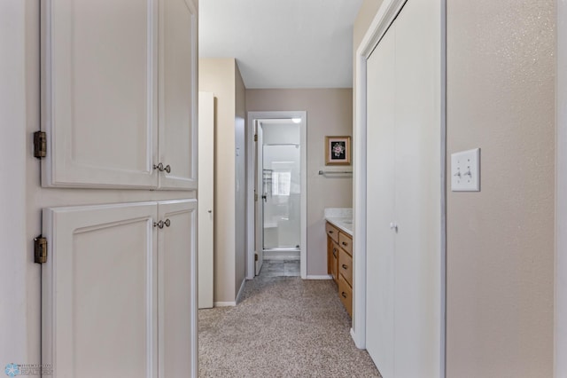 hallway featuring light carpet