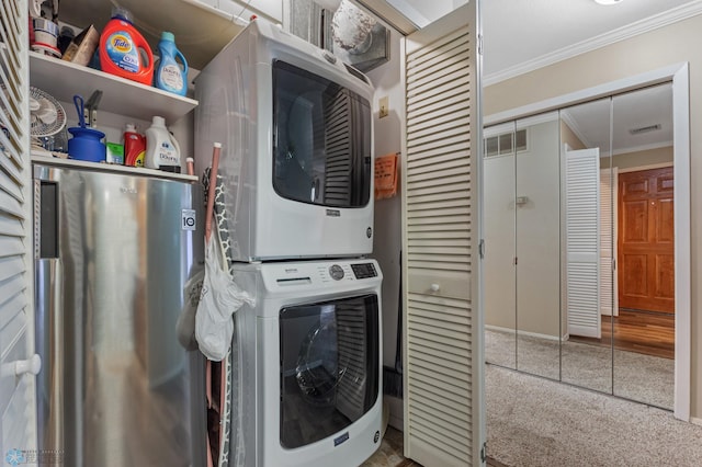 washroom featuring crown molding and stacked washer and clothes dryer