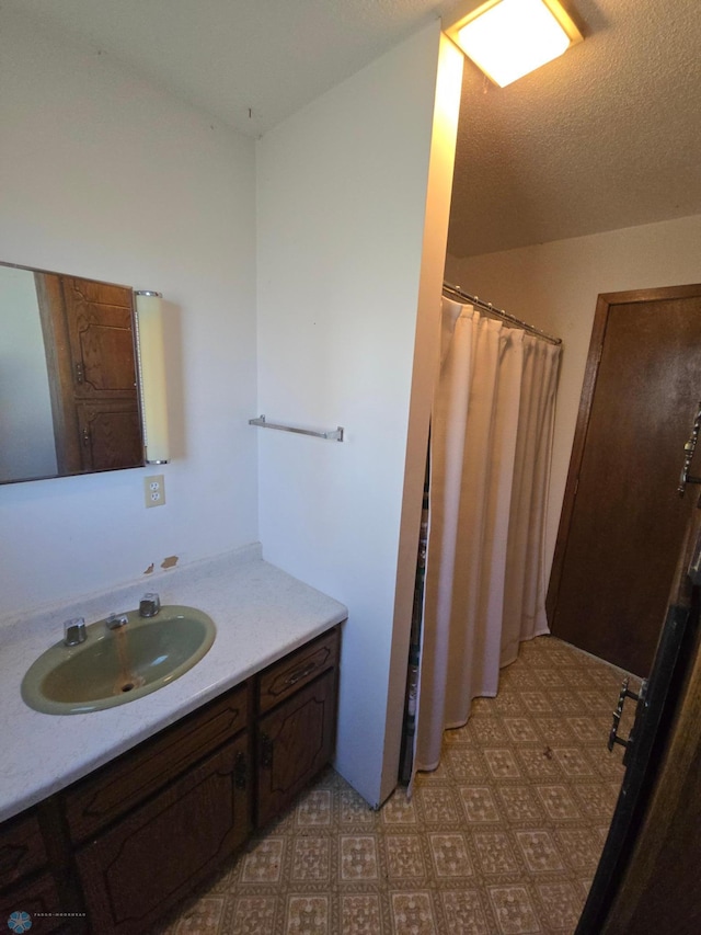 bathroom with vanity and a textured ceiling