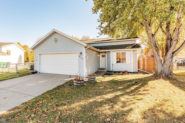 ranch-style home featuring a front lawn and a garage