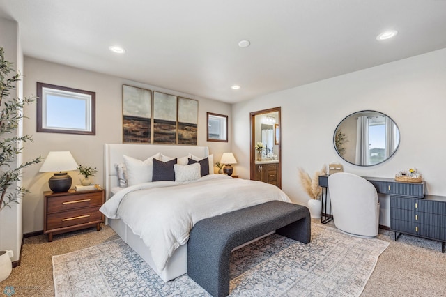 carpeted bedroom featuring ensuite bath