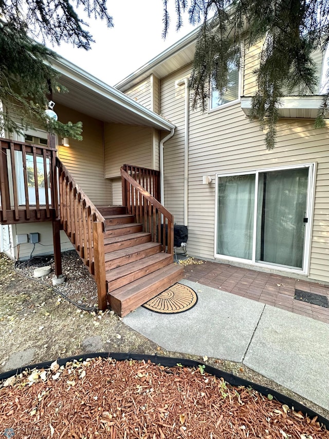 entrance to property featuring a patio area