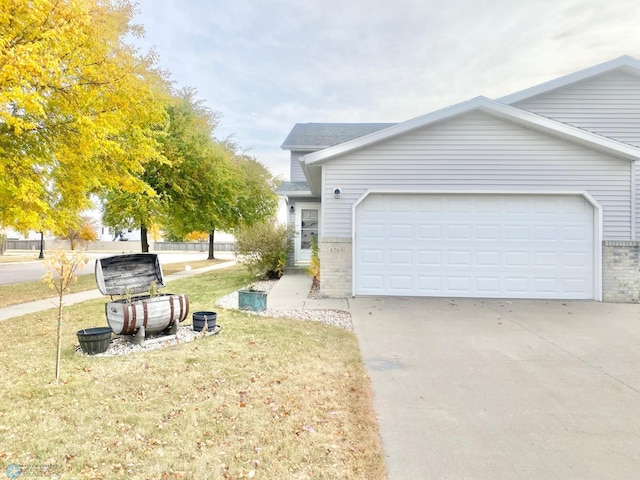 view of side of property with a lawn and a garage