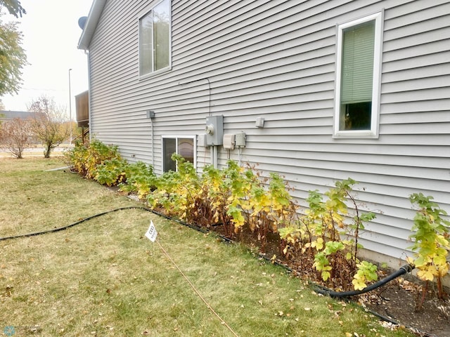 view of side of property with a yard