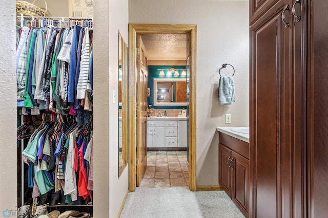 bathroom with vanity, decorative backsplash, and a textured ceiling