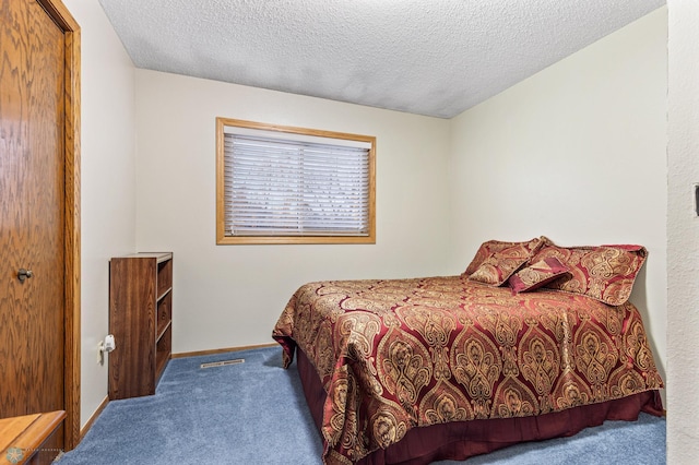 carpeted bedroom with a textured ceiling